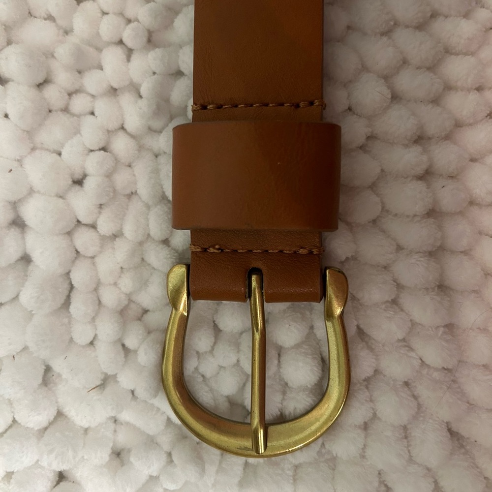Brown belt, with gold accents. Never worn. Too big for me